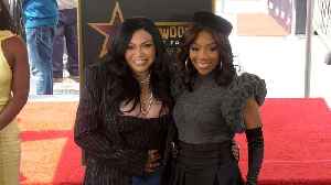 Tisha Campbell and Brandy pose together next to Brandy's star on the Hollywood Walk of Fame