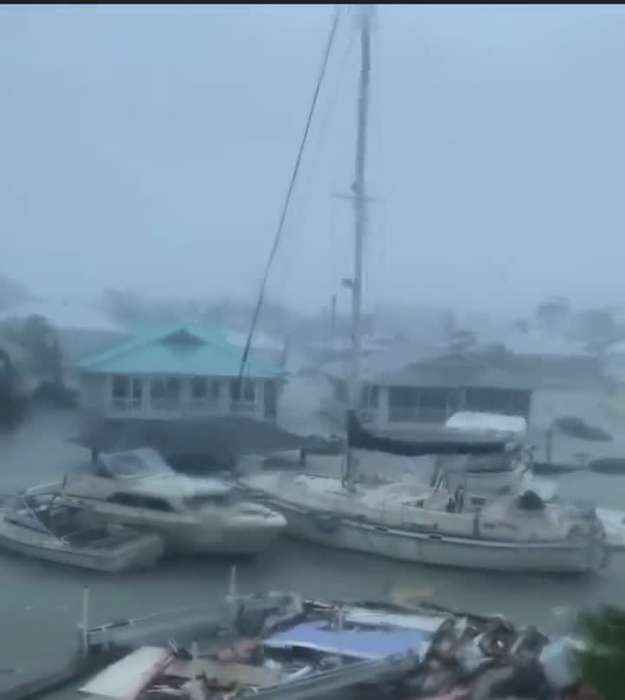 Hurricane Ian doing unreal damage to Florida, yachts floating by.