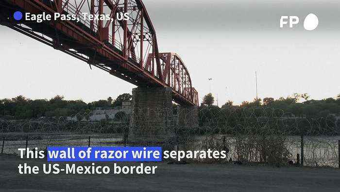 Migrants wade through river and wire to cross US-Mexico border