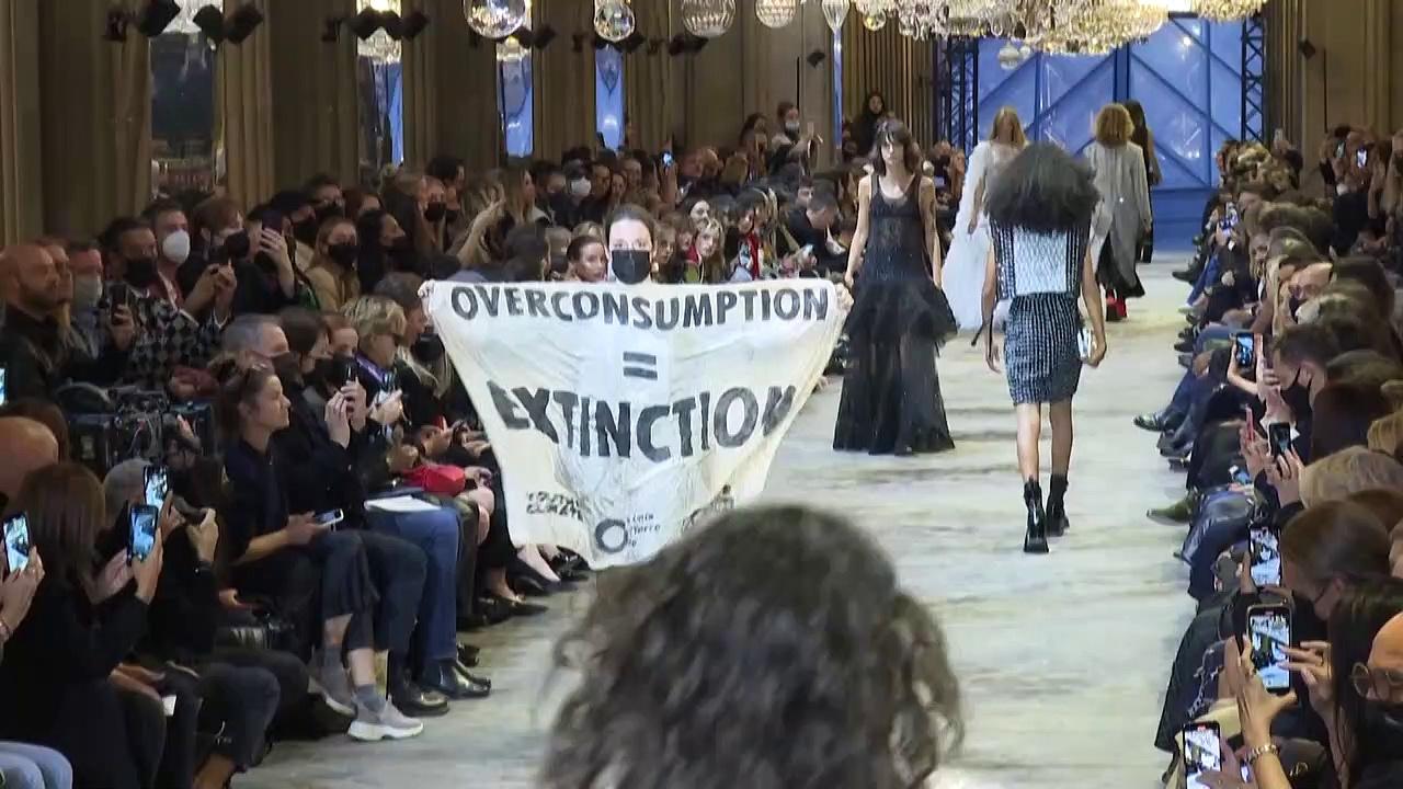 Climate protesters invade the Louis Vuitton fashion show in Paris