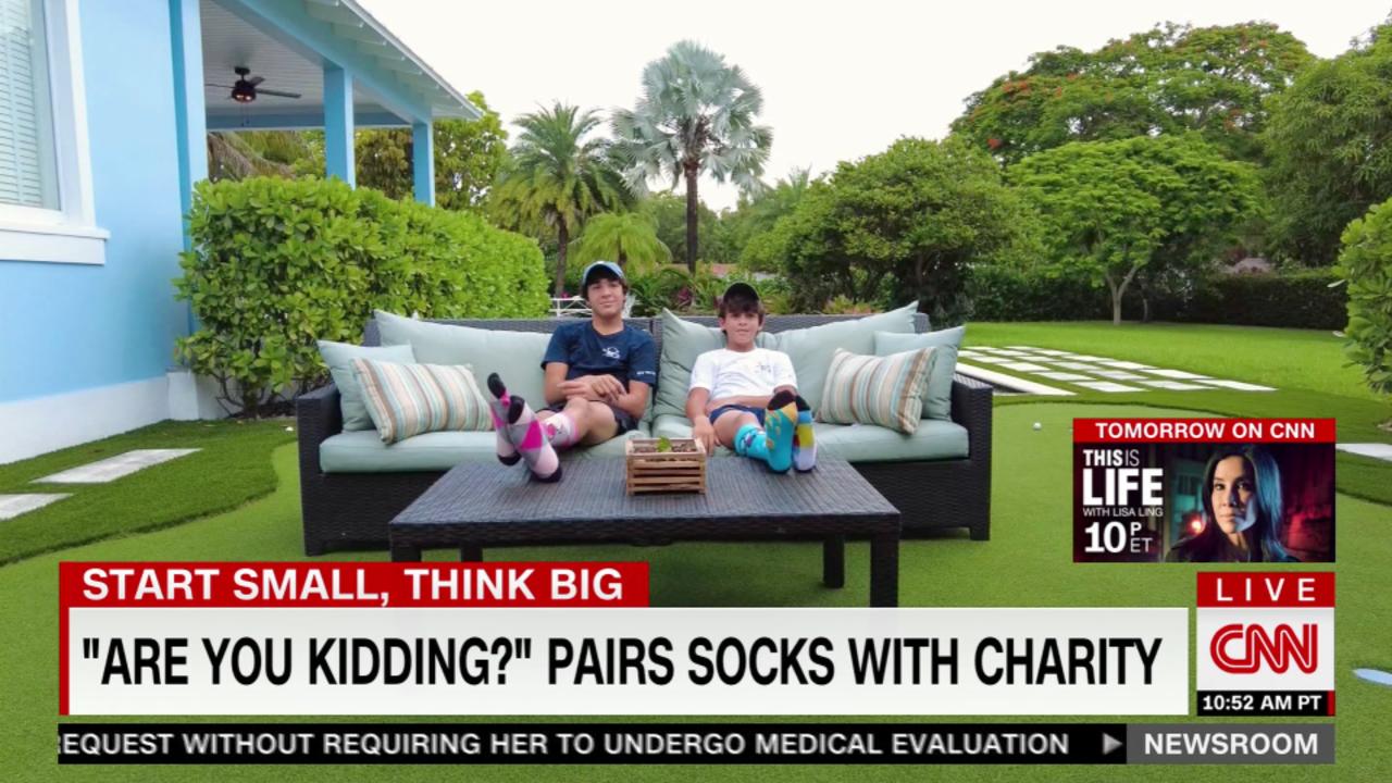 Two young entrepreneurs sell socks for charity