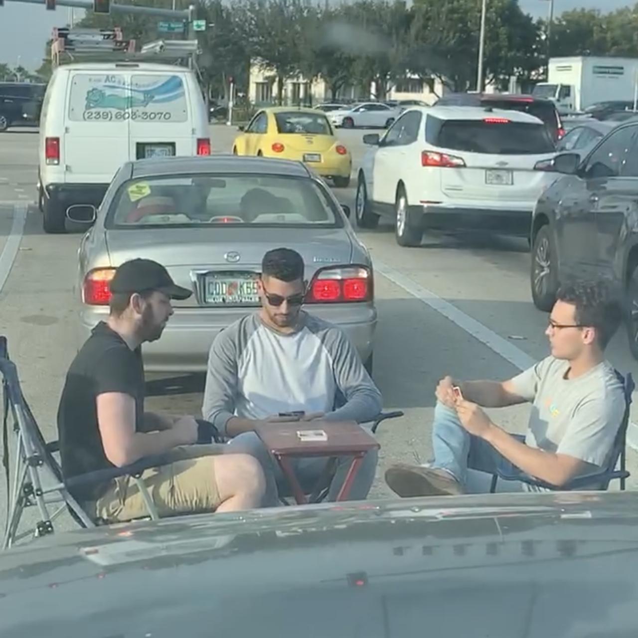 A card game was played in the middle of traffic