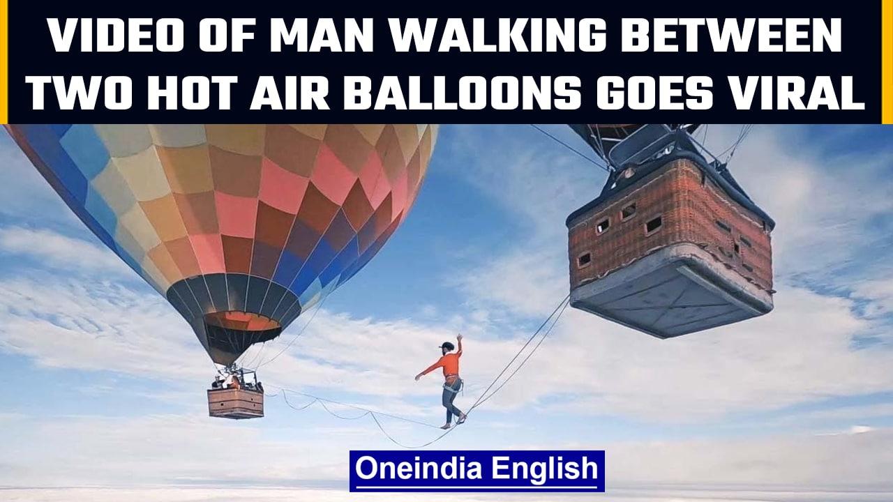 Man walks on a rope tied between two hot air balloons, creates world record | OneIndia News