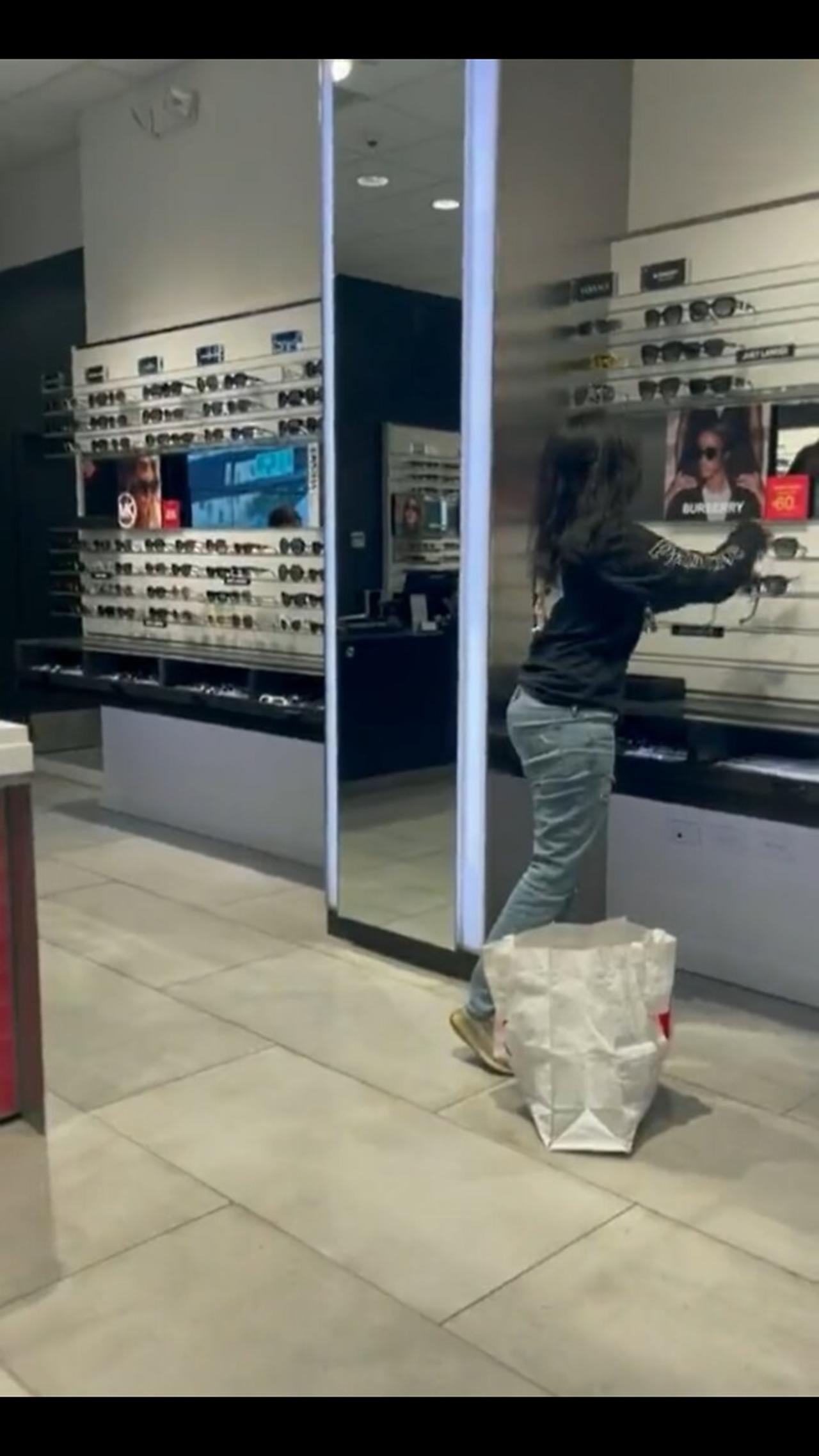 A Woman Casually Steals Sunglasses From A Store