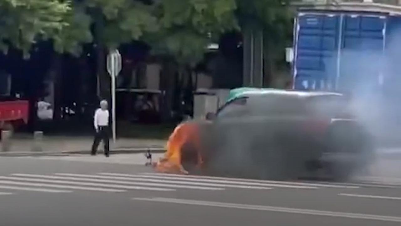 Sedan with burning wheel drives on road in China