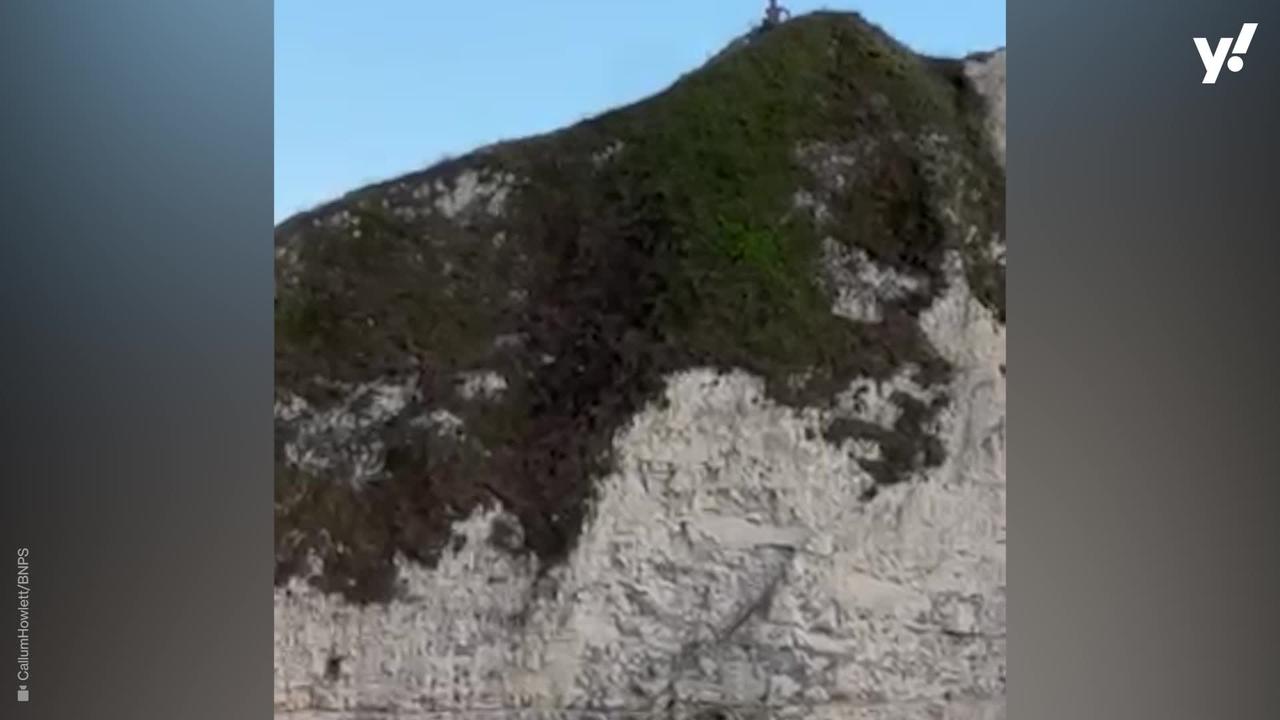 Heartstopping moment tourist slips on cliff edge above 120ft drop