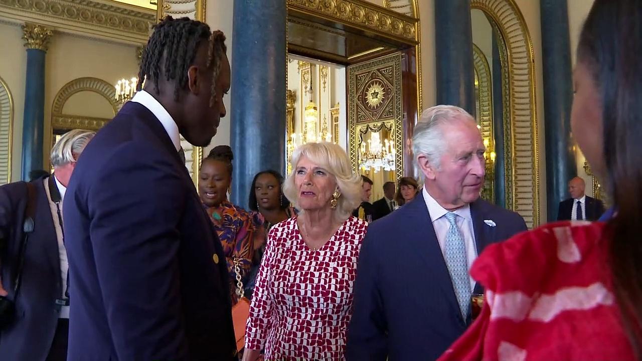 Charles has a laugh with footballer at Commonwealth Diaspora