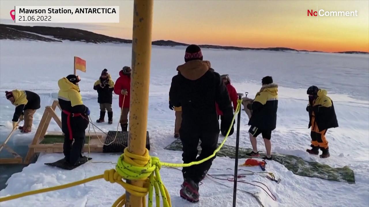 Australian Antarctic mission take traditional icy plunge