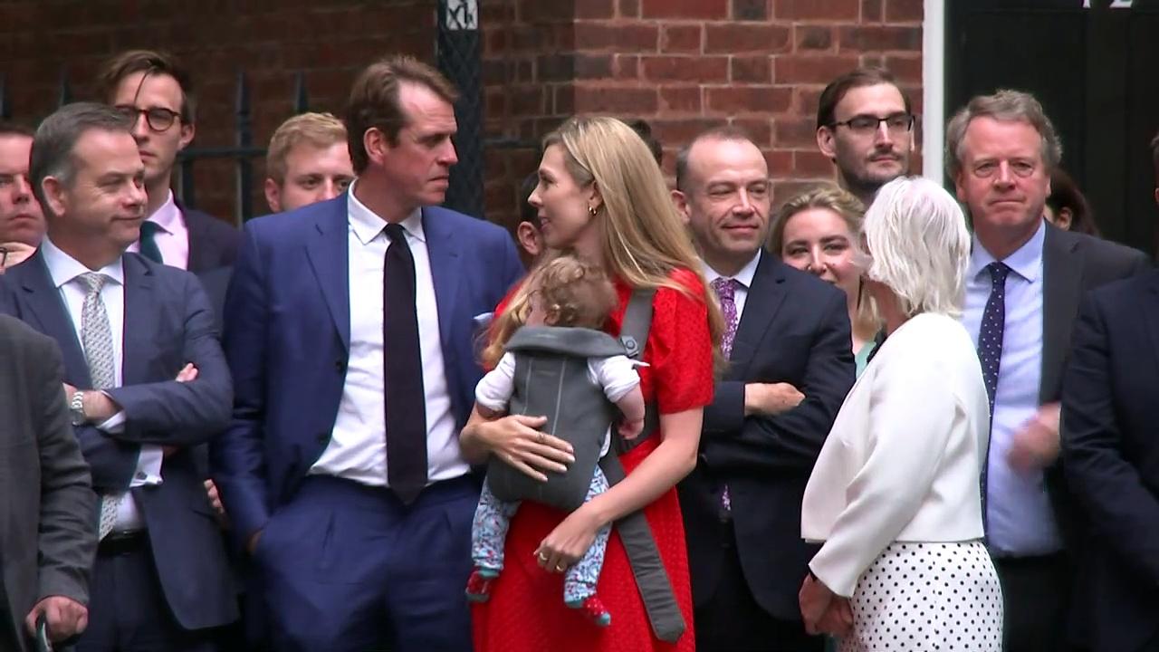 Carrie Johnson and baby Romy watch on as PM resigns