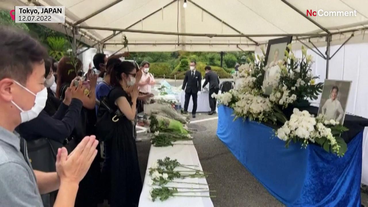 People pay their respects to Abe at temple