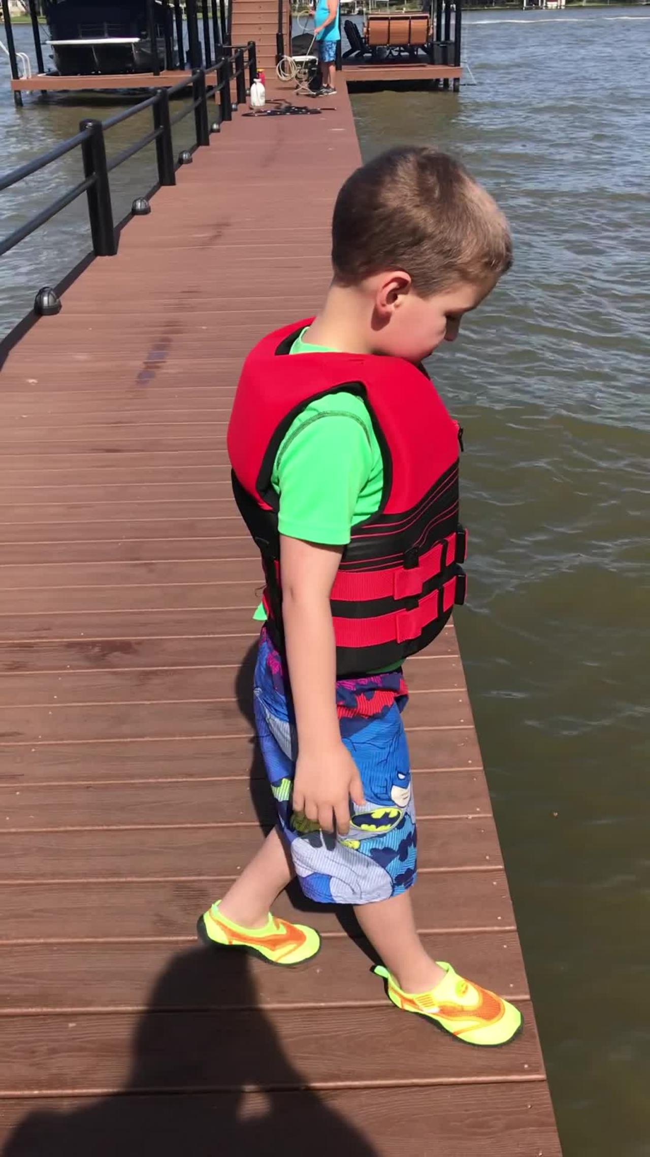 Kid Tries to Hype Himself Up to Jump Off Dock