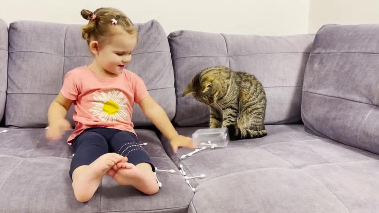 Cute_Baby_Trying_to_Clean_Cat_Ears_with_Cotton_Buds