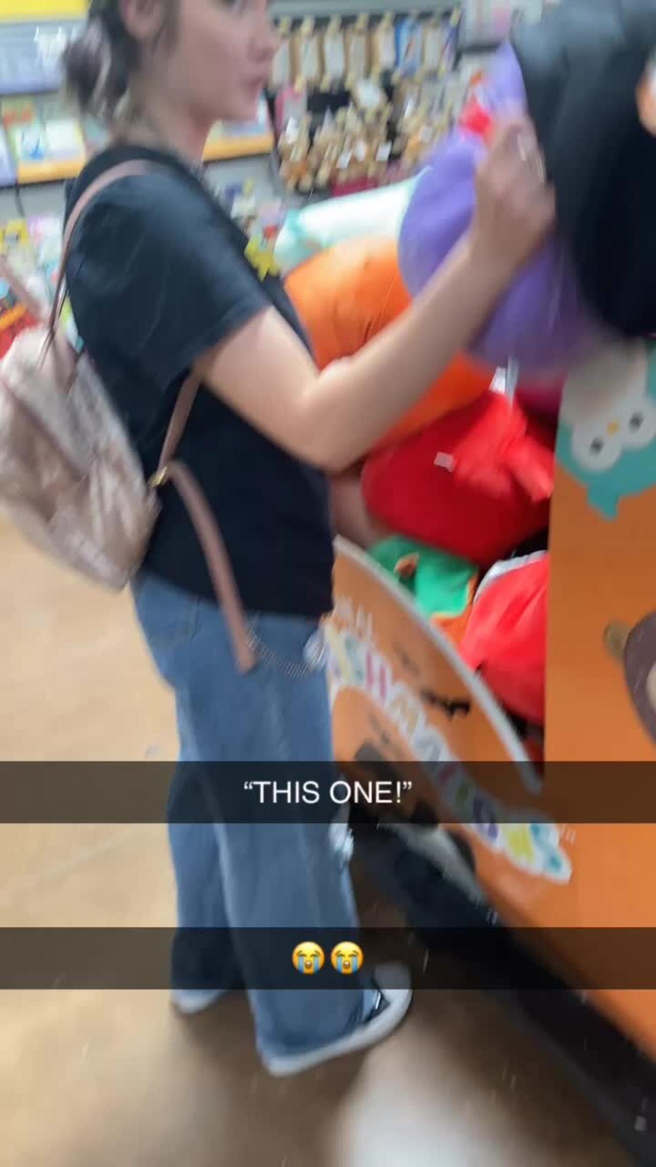Girl is digging through a box of Halloween Squishmallows at Walmart!.MOV