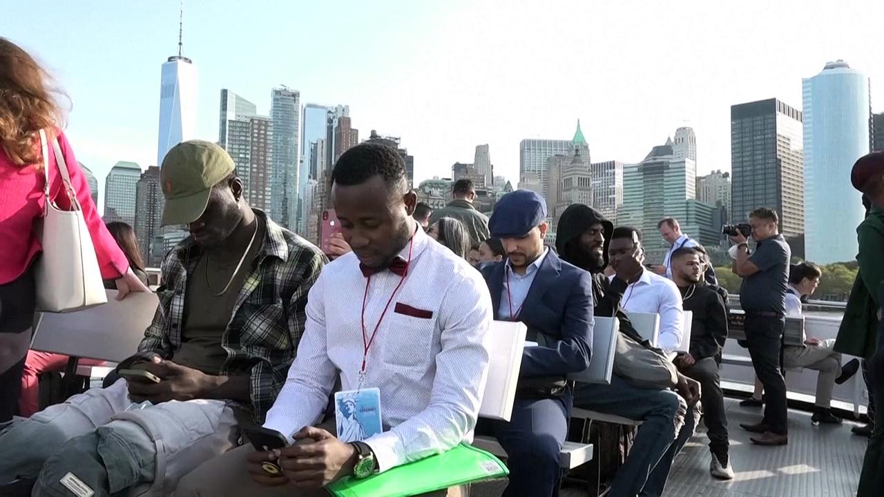 New US citizens take oath of allegiance on Ellis Island