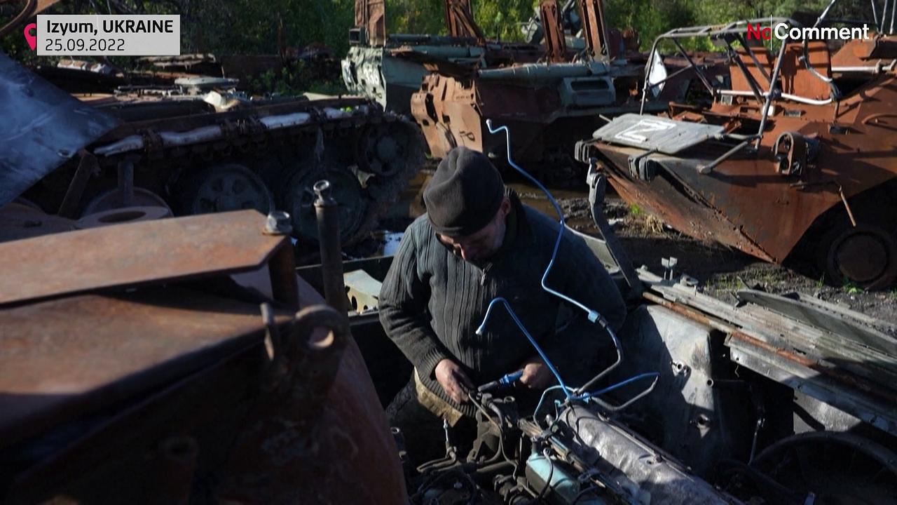A Ukrainian mechanic strips Russian tanks for parts.