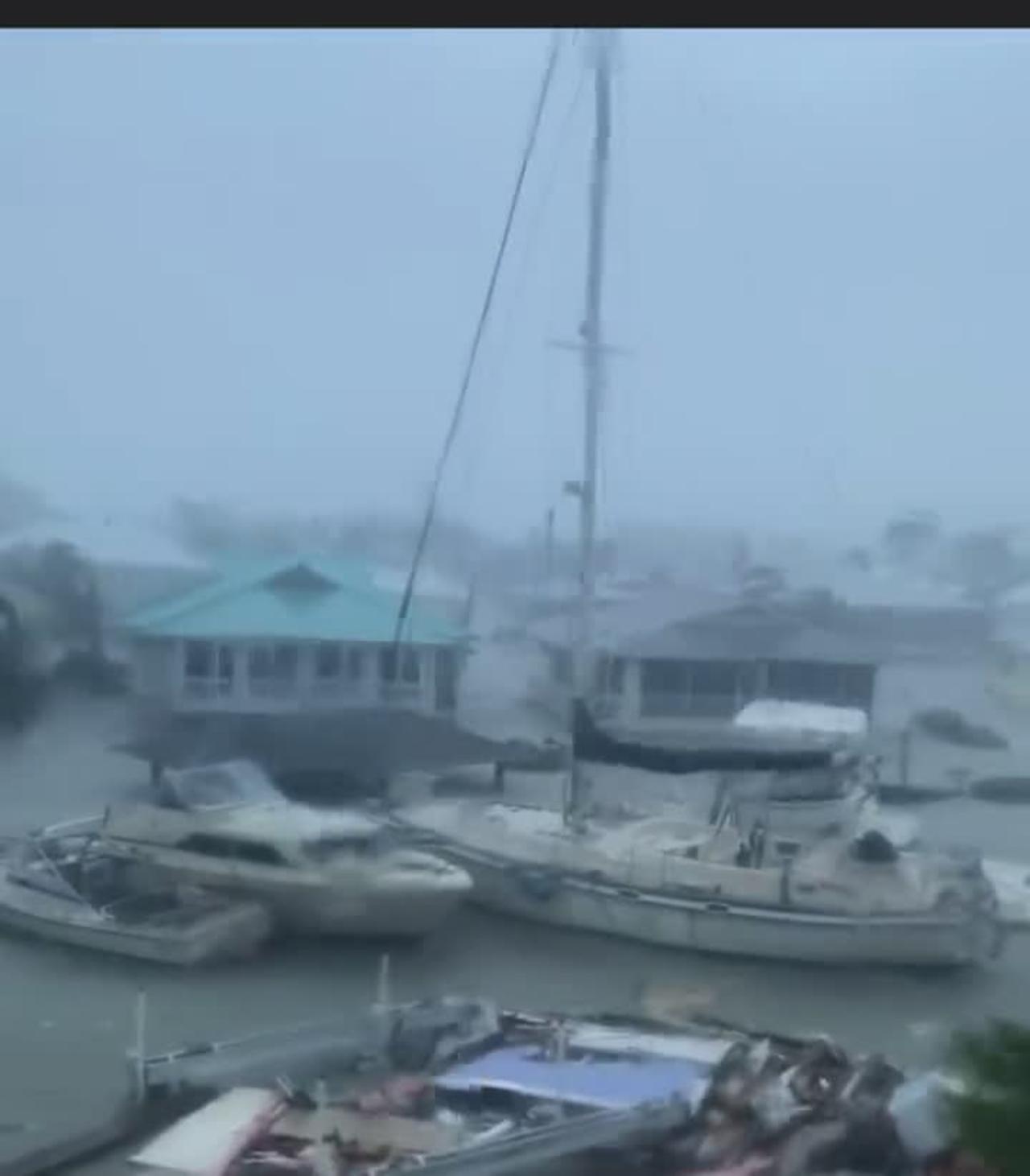 Hurricane Ian doing unreal damage to Florida, yachts floating by.