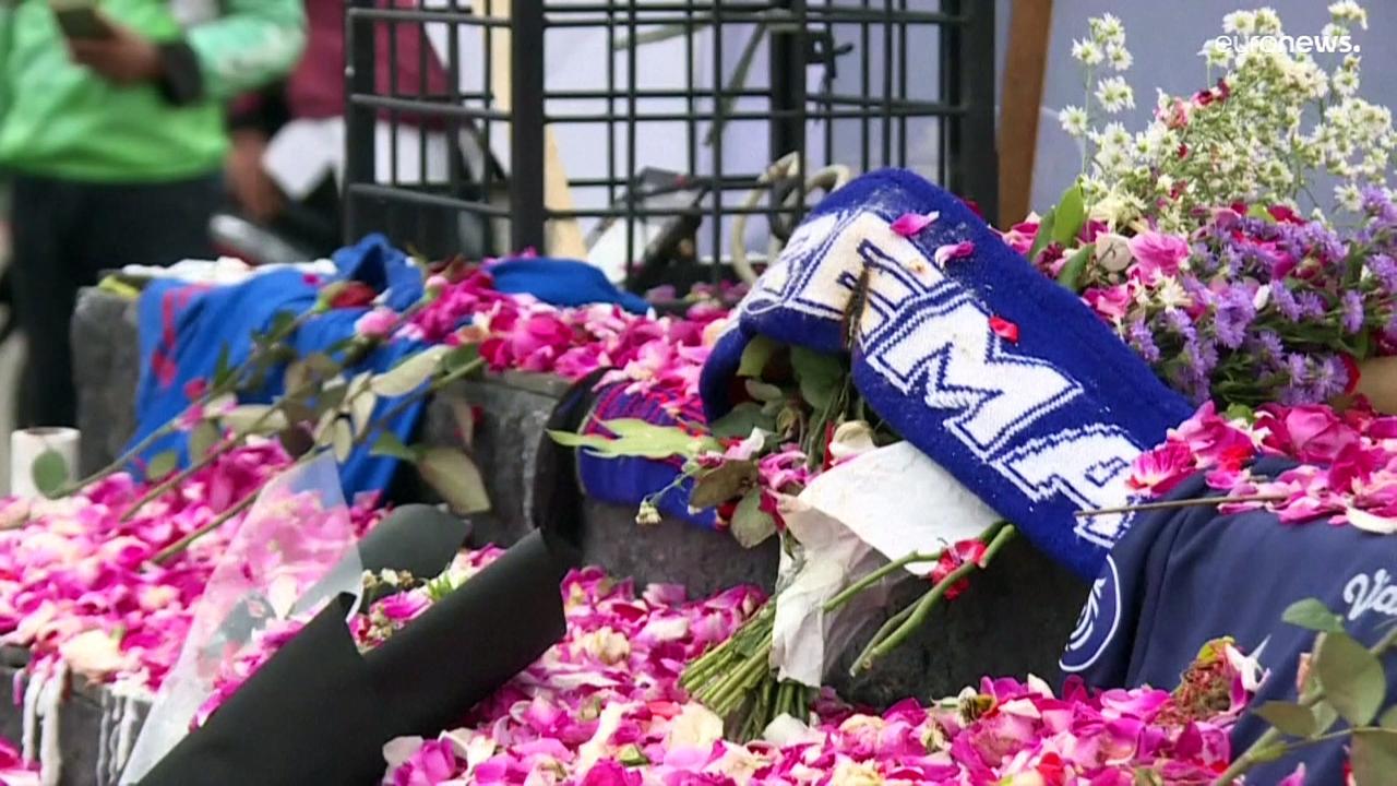 Fans and players pray for victims of Indonesia's football stadium disaster
