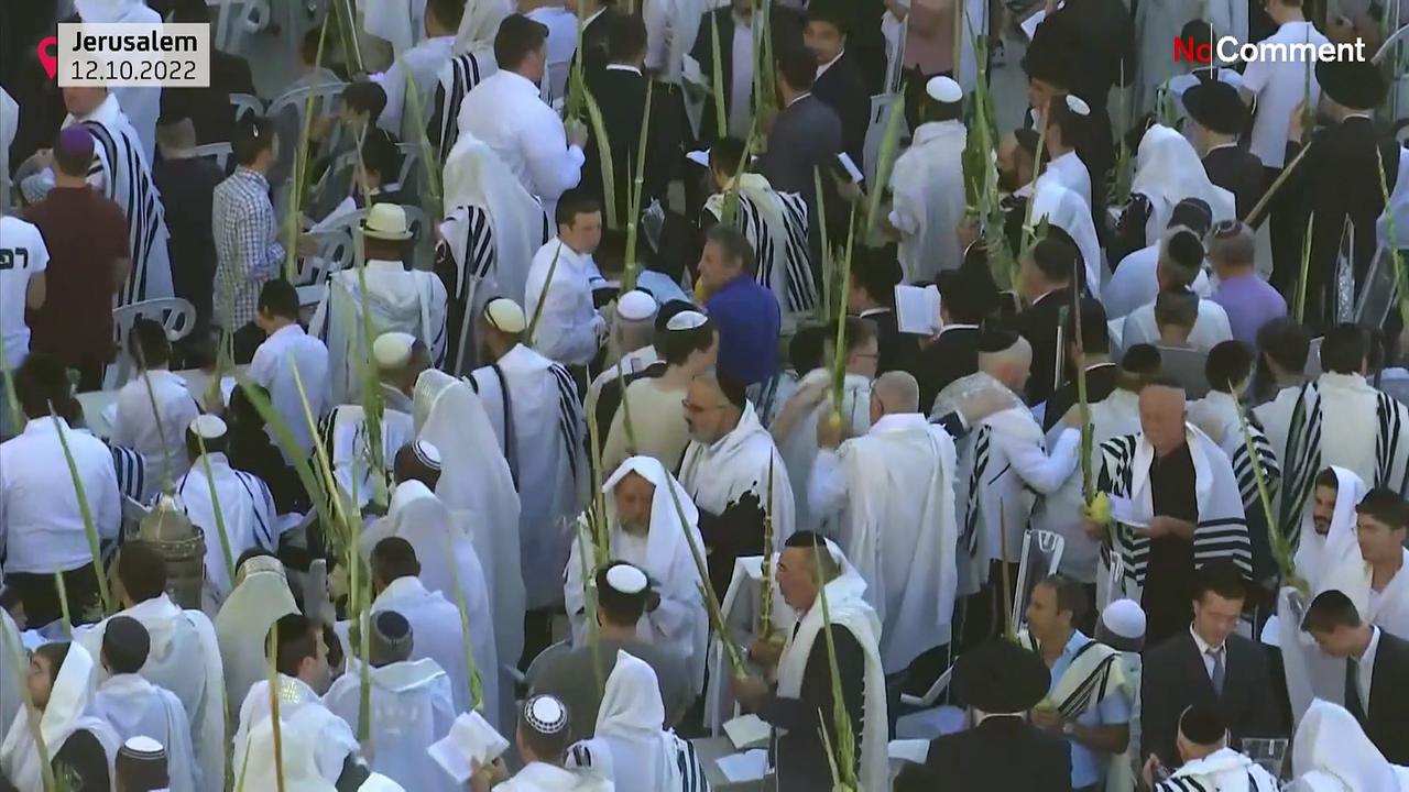 Worshippers pray by Western Wall during Sukkot