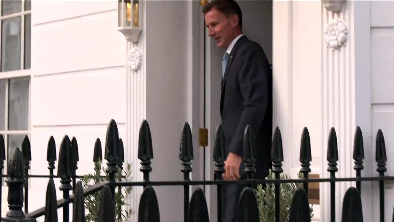New chancellor is questioned outside his home
