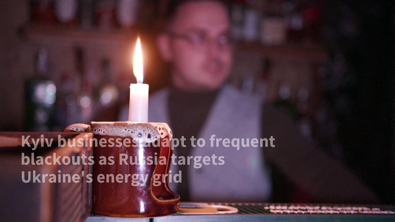 Diners in Ukraine's Kyiv eat by candlelight as power cuts bite