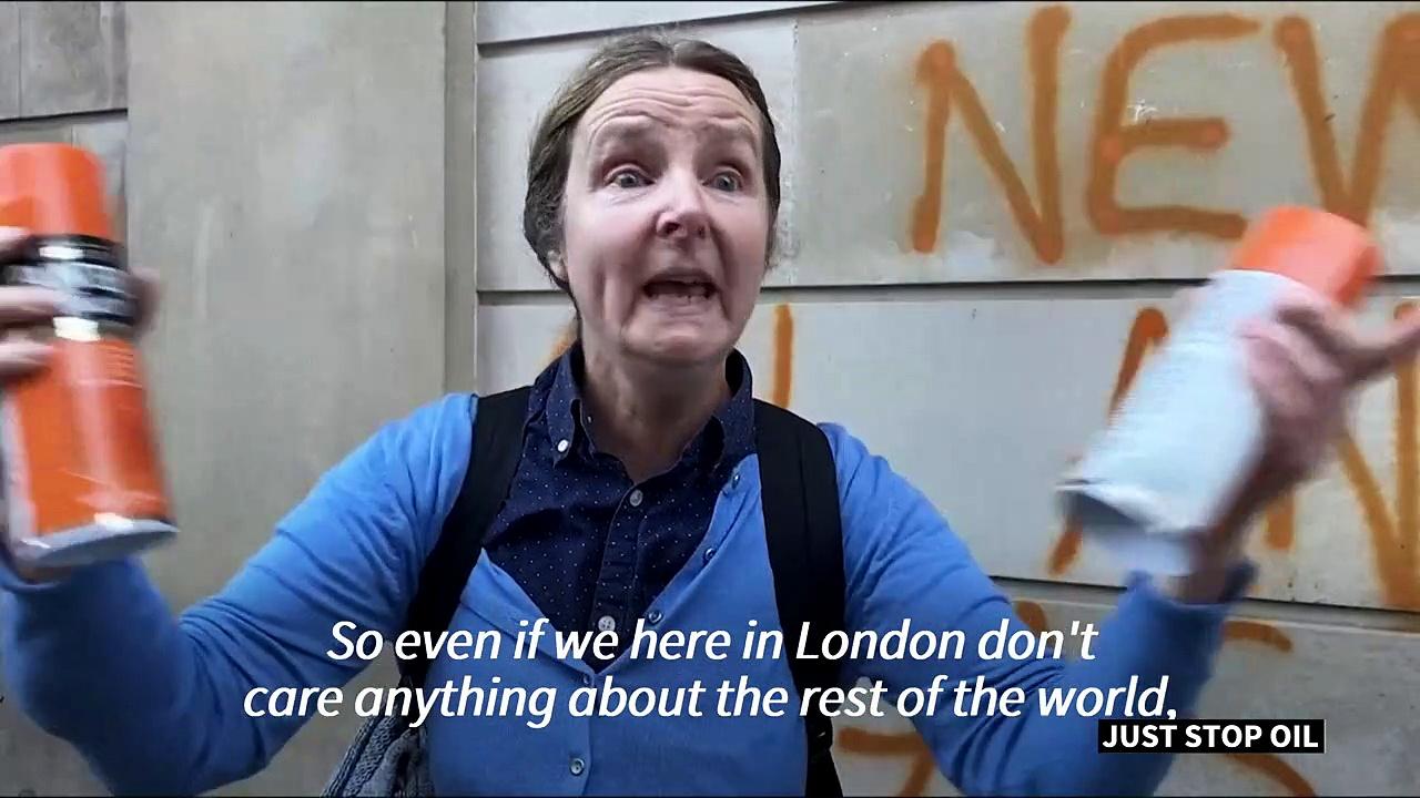 Climate activists spray-paint London landmarks orange