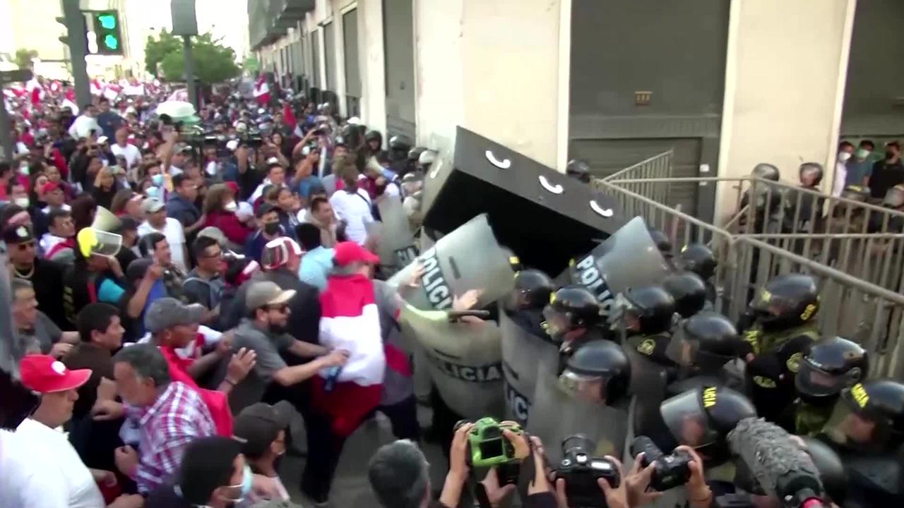 Anti-government protesters face down tear gas in Peru
