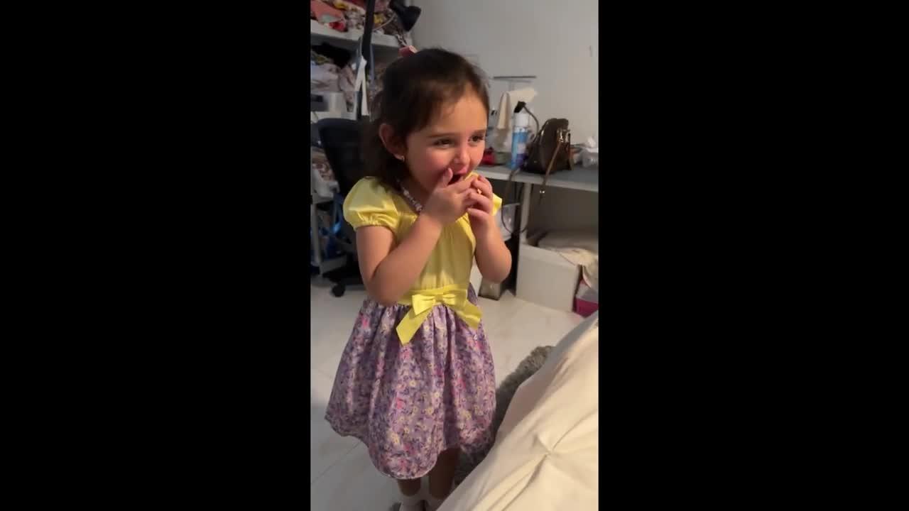 Little girl excitedly meets her newborn baby brother
