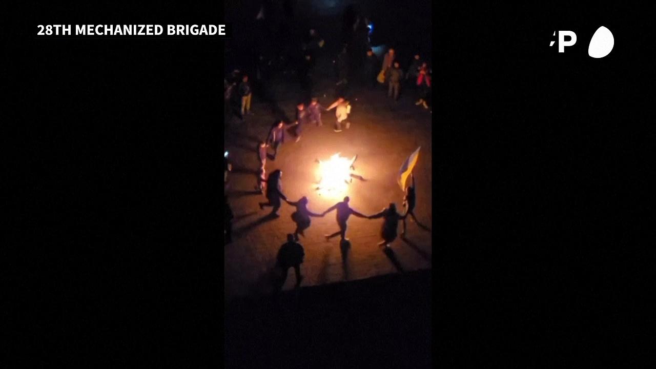 People in Kherson dance around a fire to celebrate Ukrainian forces entering the city
