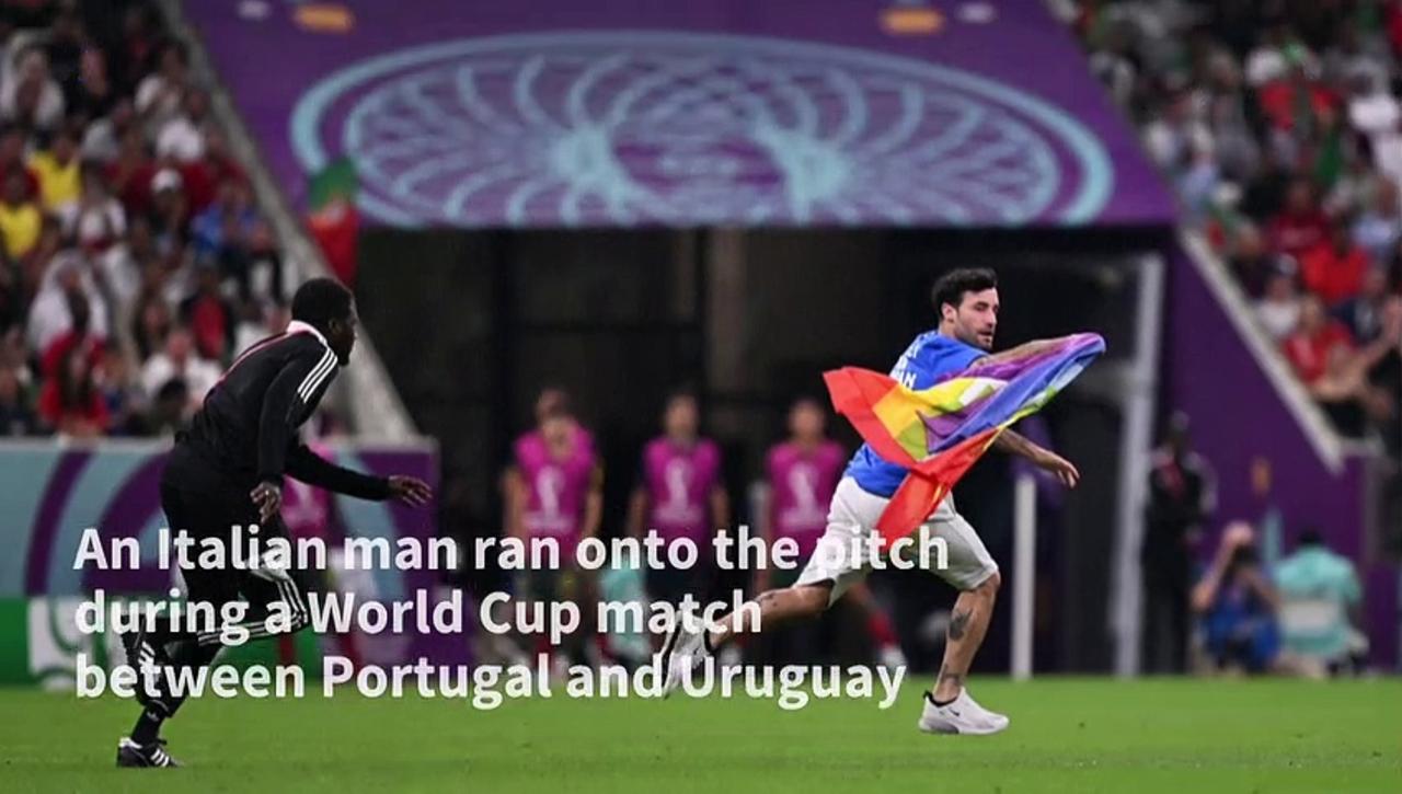 Man storms the pitch during World Cup match brandishing rainbow flag
