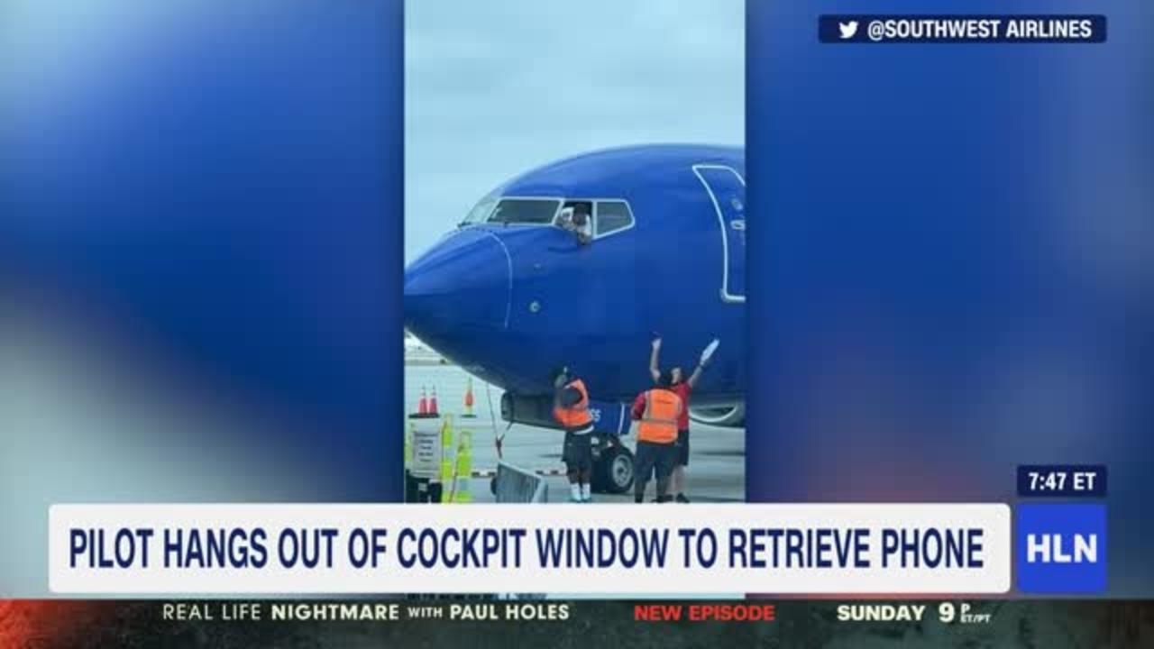 Pilot hangs out of cockpit window to retrieve passenger s phone