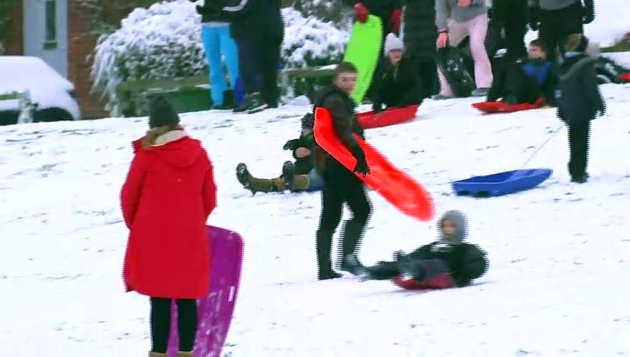 Children go sledding as snow shuts schools