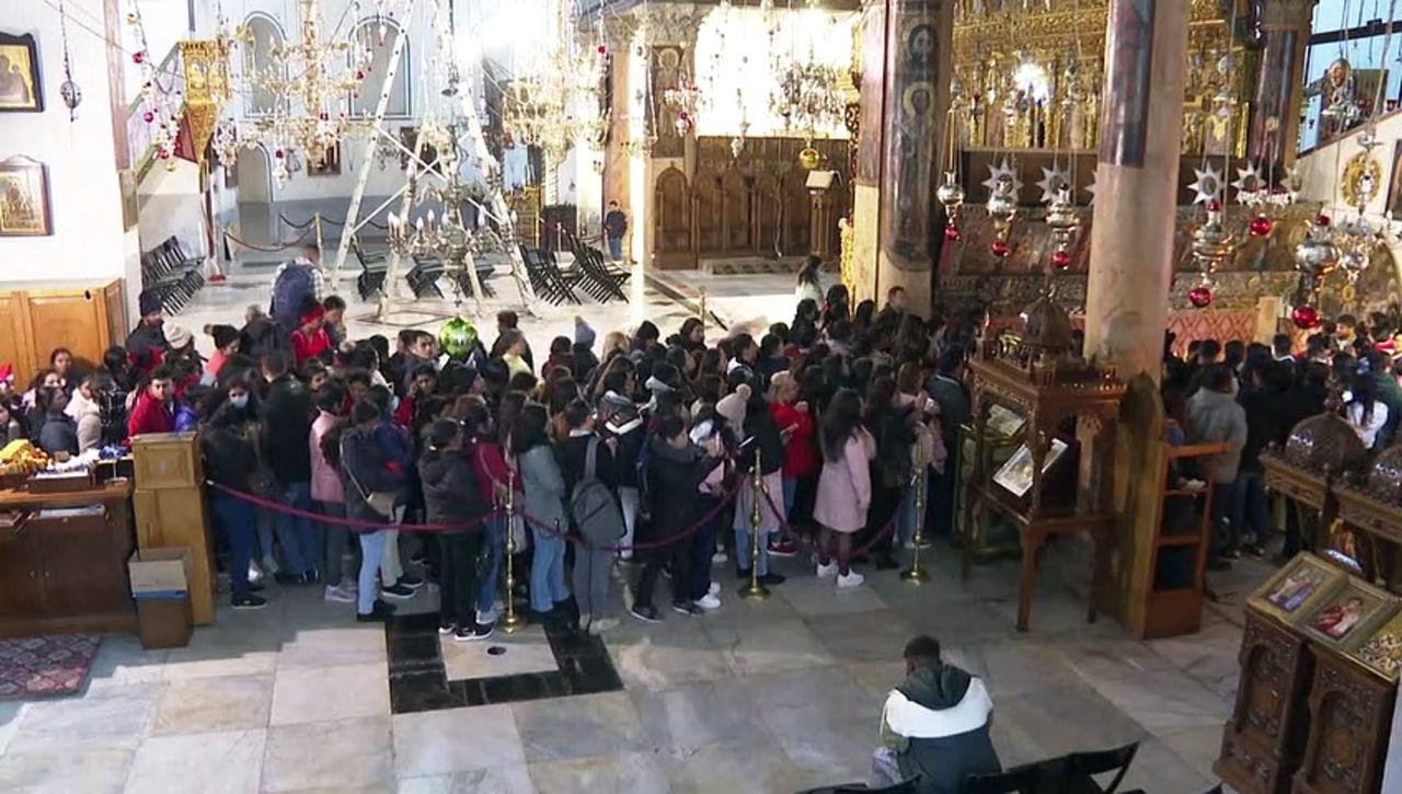 Tourists visit Bethlehem's Church of the Nativity on Christmas Eve