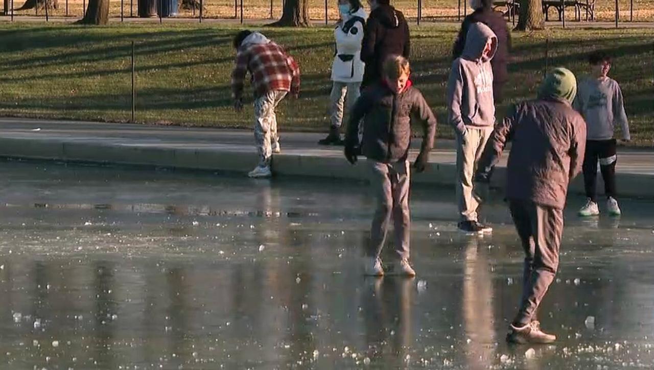 Visitors walk on thin ice at DC's frozen Lincoln Memorial Reflecting Pool