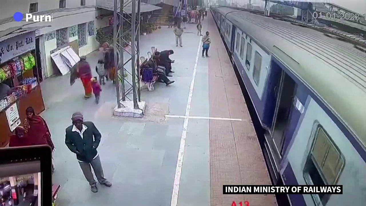Indian soldier saves man from being pulled under a moving train