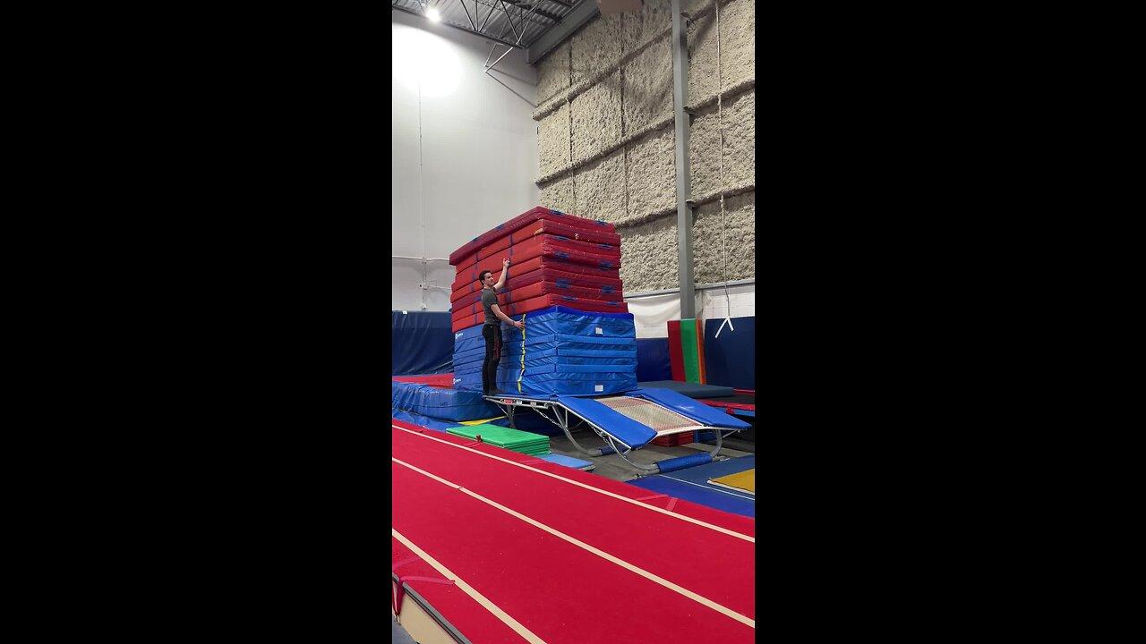 Person jumps over a huge stack of mats using a double mini trampoline!.MOV