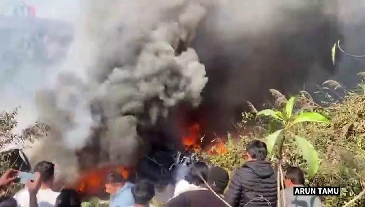 Fire and plumes of smoke moments after plane crash in Nepal