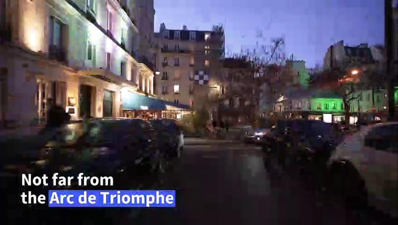 In Paris, a stone's throw from the Arc de Triomphe, migrants are housed in a car park