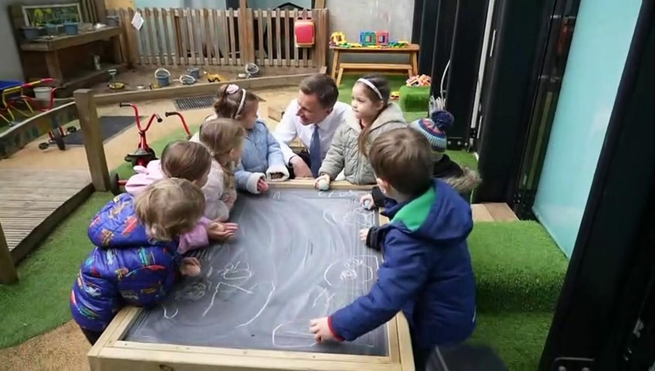 Hunt helps make Mother's Day cards with nursery children