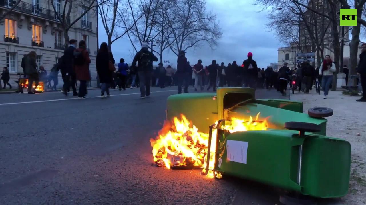 Trash cans set on fire as protest over pension reform grips Paris
