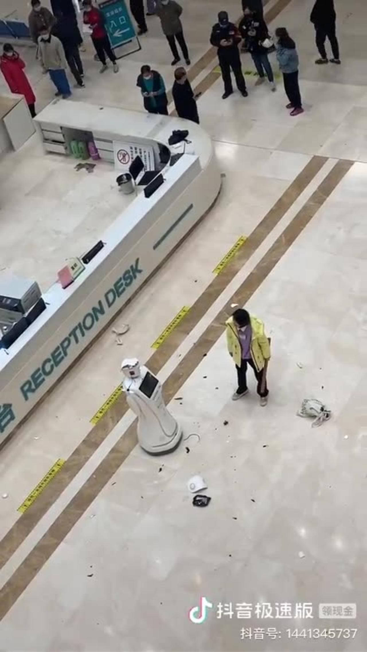 Chinese woman smashes up a robot in the hospital.