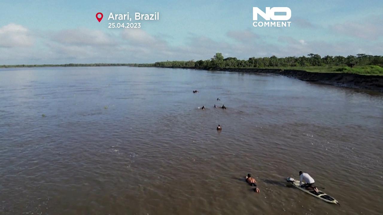 WATCH: surfers braving the wave during a tidal surge in Brazil