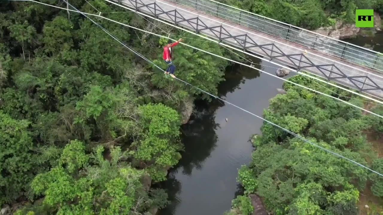 Chinese athletes walk tightrope over rainforest