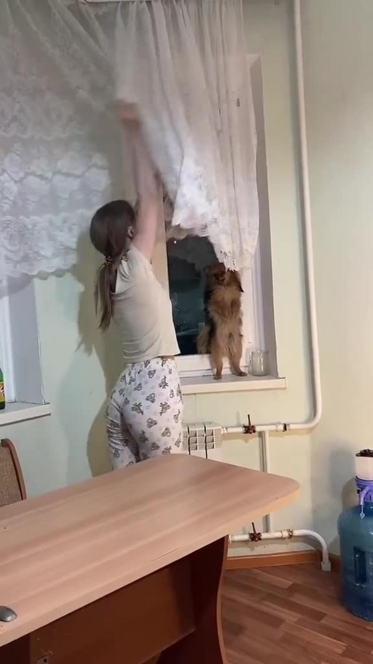 this woman wanted to reach the curtains but did not reach