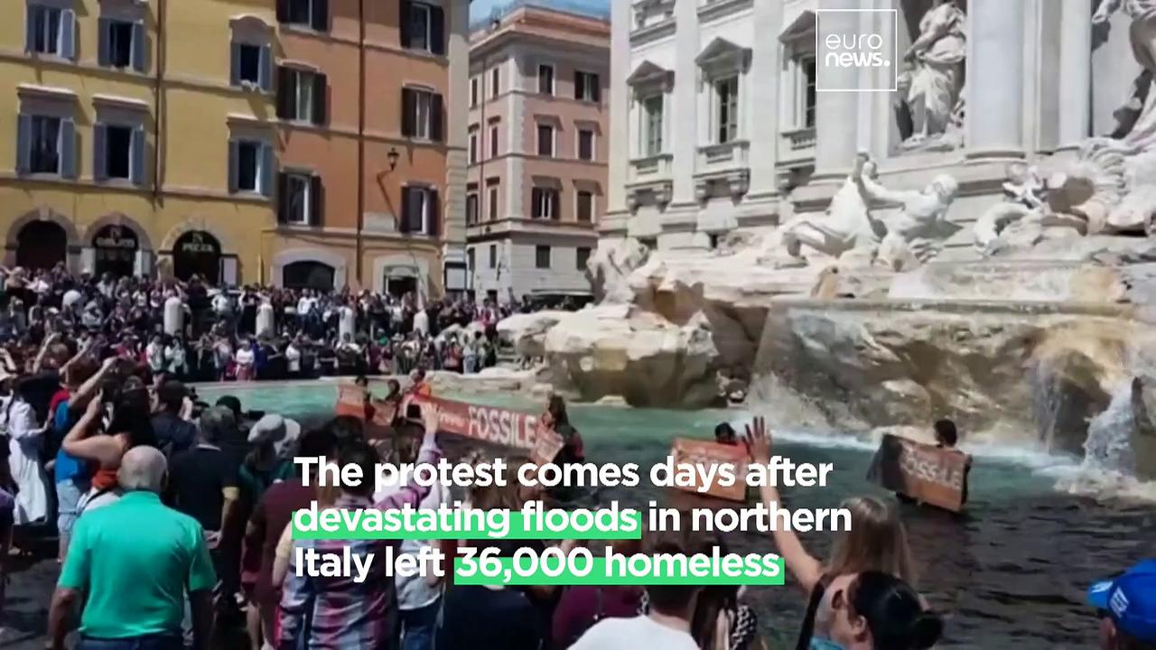 Activists wade into Rome’s Trevi Fountain to warn of the ‘black future that awaits mankind