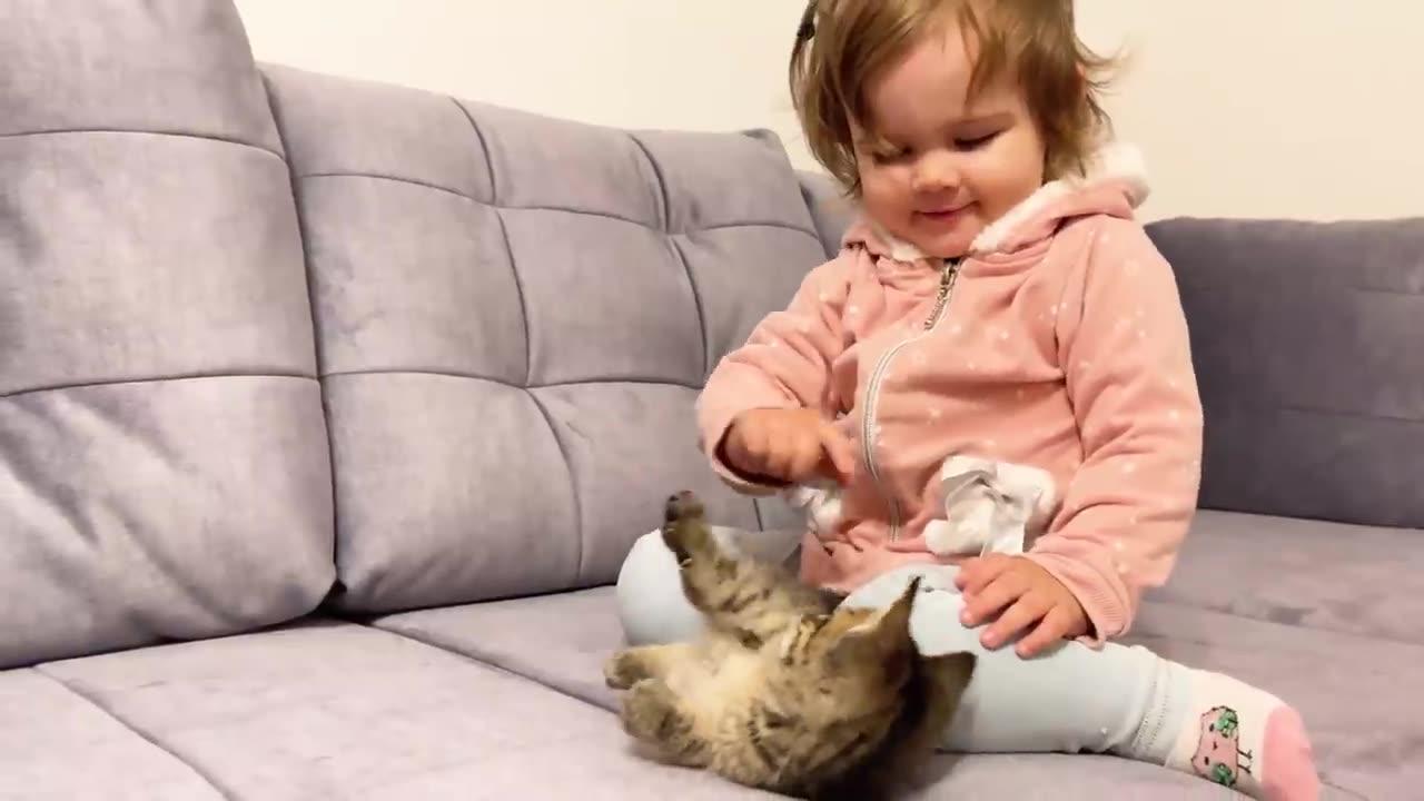 Cute baby meets new baby kitten for the first time