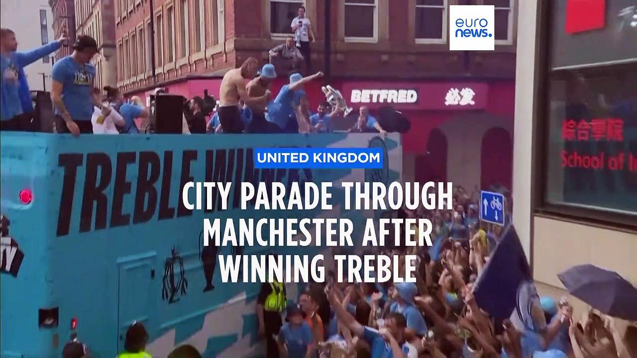 Rain and champagne: Man City celebrate this season's treble with fans