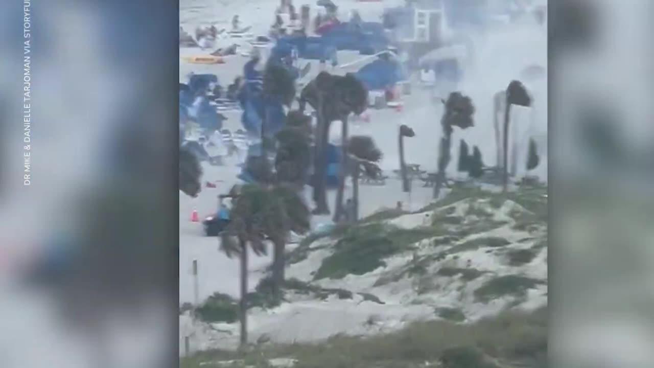 Cameras capture waterspout ripping through crowded beach
