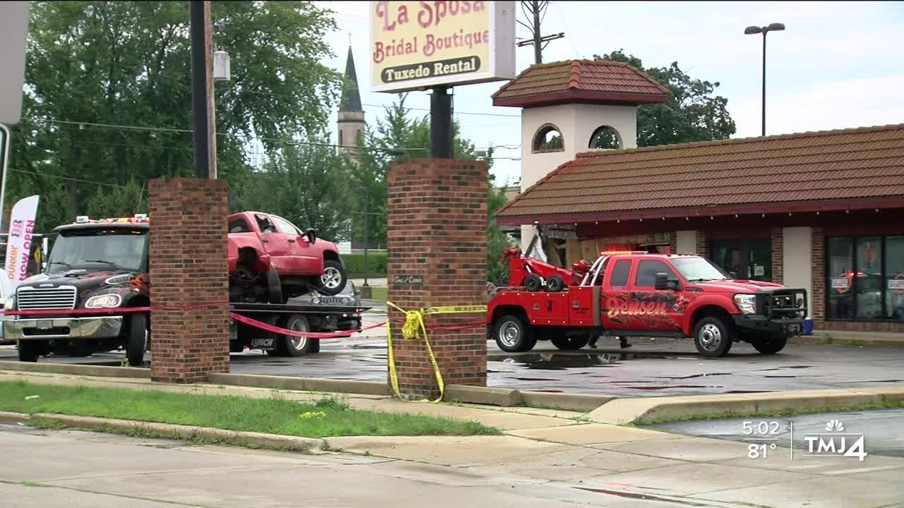 Truck crashes into business, killing 2