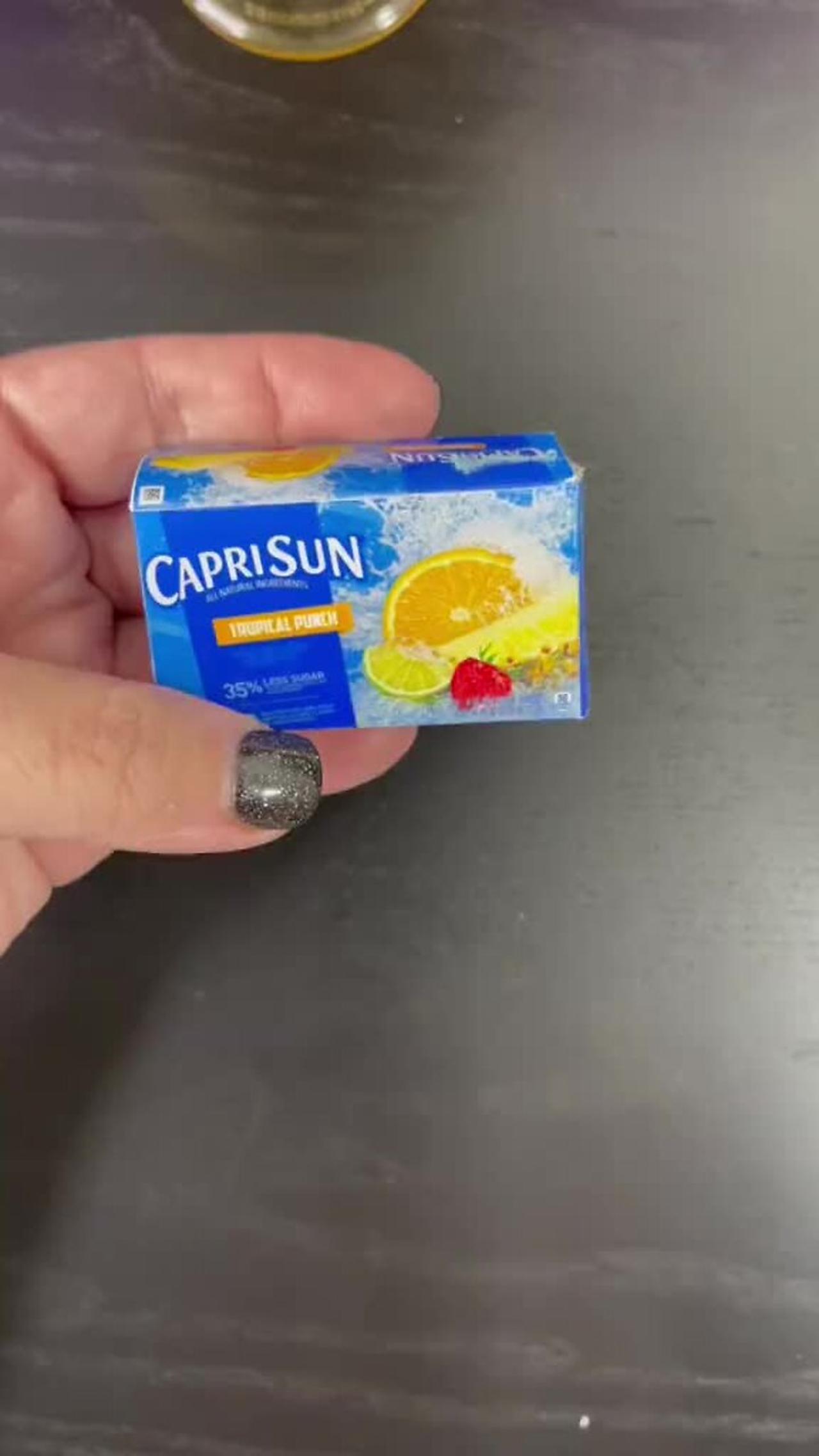 Person is showing miniature Capri Sun drinks!.mp4