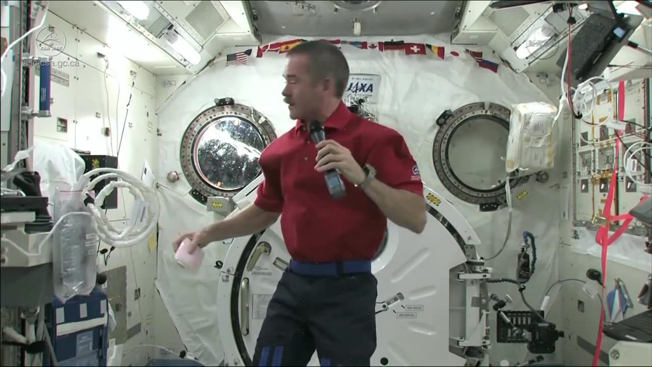 Astronaut Chris Hadfield demonstrates how to contain vomit in space.